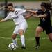 Dexter senior Hannah Ruble competes for possession of the ball with Huron junior Kelsey Trulik on Tuesday, April 23. Daniel Brenner I AnnArbor.com